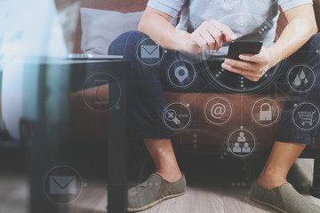 hipster hand using digital tablet docking keyboard and smart phone for mobile payments online business,omni channel,sitting on sofa in living room,green apples in wooden tray