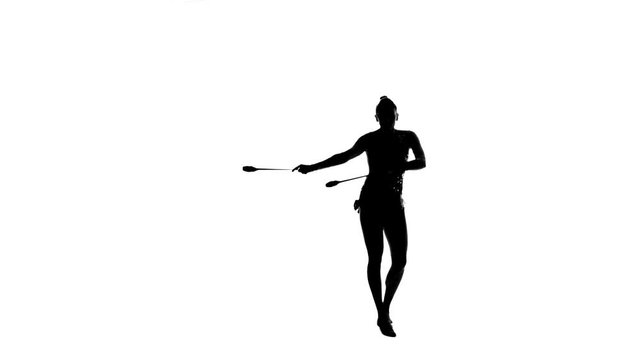 Gymnast holding a mace and makes artistic movement. White background. Silhouette