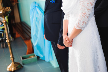 groom holds the hand of the bride