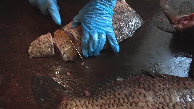 Cleaning and cutting of large fresh carp fish
