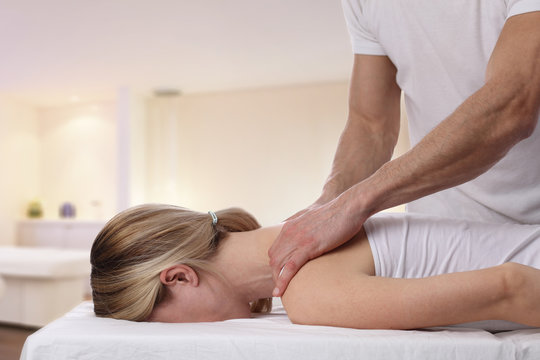 Young woman having massage. Relaxation, body care treatment, Osteopathy, Alternative medicine, pain relief , Physiotherapy, Sport injury rehabilitation
