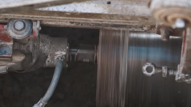Industrial circular drill to screw concrete in dirty ditch at building site. Close up