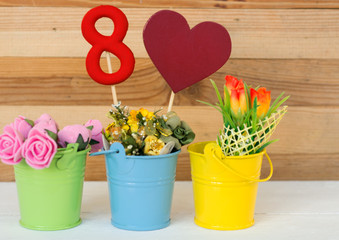 lollipop  shape figure eight 8, note for text, flowers in colored buckets. Happy International Women’s Day celebrate on March 8, congratulatory CARD. 