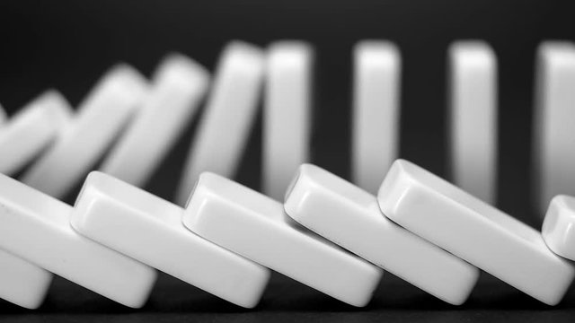 built figure of dominoes falling in slow motion