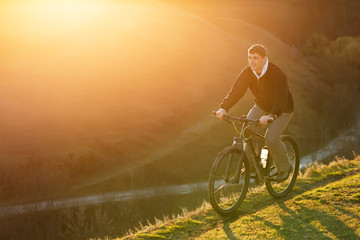 Fototapeta na wymiar Mountain Bike cyclist riding single track at sunrise, healthy life
