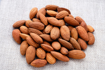 handful of almonds close up on linen material