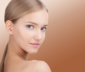 Beauty Woman face Portrait. Skin Care Concept Isolated on gold background