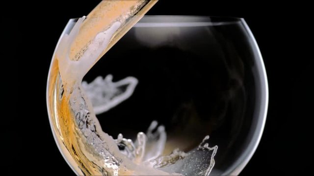 Pouring beer into glass. Shot with high speed camera, phantom flex 4K. Slow Motion.