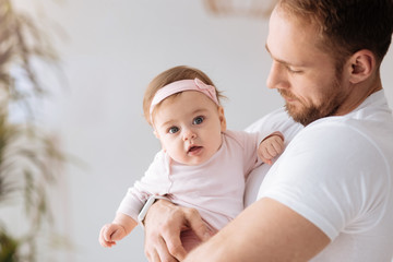 Cheerful young man spending weekend with his baby