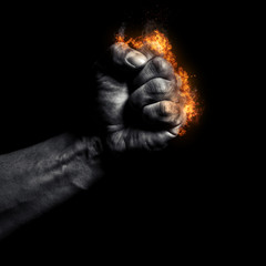 Burning man's clenched fist on a black background - 137518288