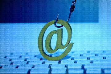 Email sign with a fish hook on computer keyboard. Email security and countermeasure concept