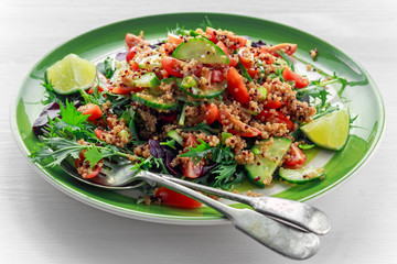 Quinoa tabbouleh salad with tomatoes, cucumber green onion. Concept healthy food