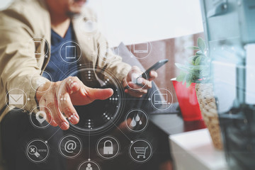 hipster hand using smart phone,digital tablet docking keyboard,coffee cup, payments online business,sitting on sofa in living room,work at home concept
