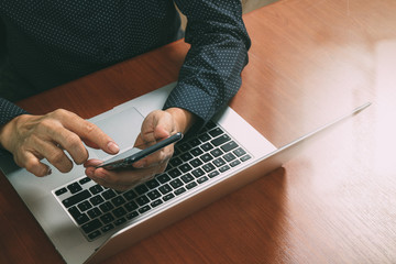top view,business man hand using smart phone,laptop, online banking payment communication network...