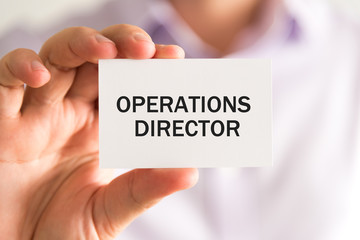 Businessman holding OPERATIONS DIRECTOR card