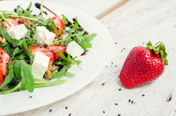 Fresh salad with arugula and strawberries