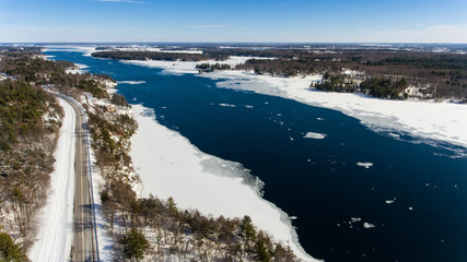 Scenic Road Along a Partly Frozen River 