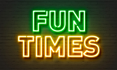 Fun times neon sign on brick wall background.