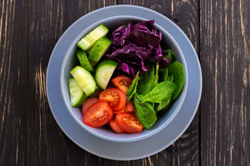 Green salad with  tomato, red cabbage, cucumber and spinach