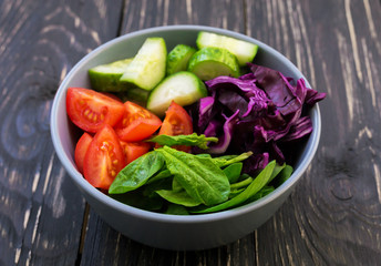 Green salad with  tomato, red cabbage, cucumber and spinach