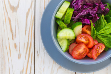 Green salad with  tomato, red cabbage, cucumber and spinach