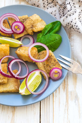 Crispy fried fish tilapia with lime and pickled onion
