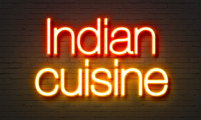 Indian cuisine neon sign on brick wall background.