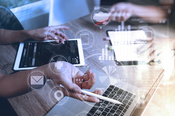 Designer and Businessman using smart phone and digital tablet and laptop computer in modern office with virtual screen interface icons diagram as concept