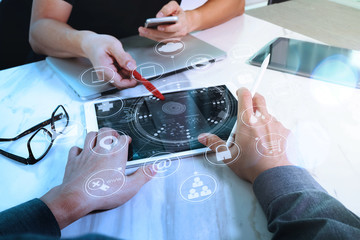 Designer and Businessman using smart phone and digital tablet and laptop computer in modern office with virtual screen interface icons diagram as concept