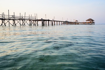 View of wooden bridge across the sea beach