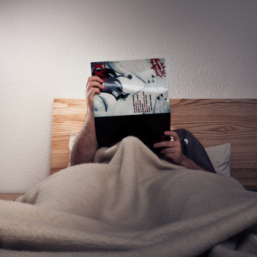 Man Enjoying A Porn Magazine