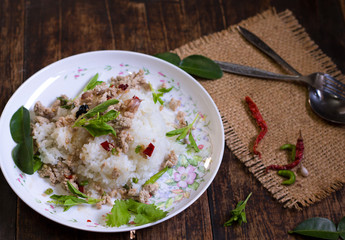 spicy stir fried chicken with basil leaf on rice in foam box for take home,fast food,.fried rice with basil