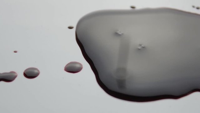 blood drop falls on the floor. macro shot.