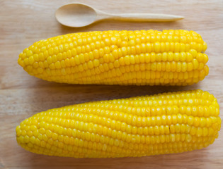 yellow sweet corn on wooden background