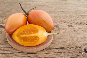 Tamarillo fruit (disambiguation) from South America, on wooden background
