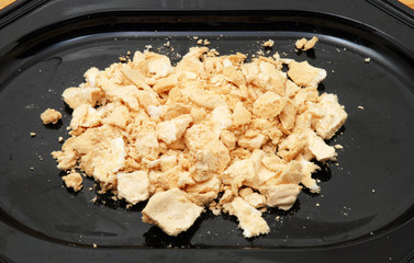 Crumbled meringue in black pot.