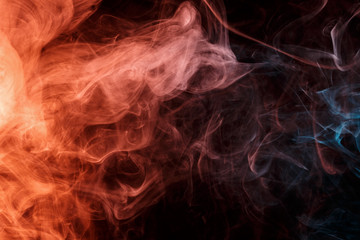 Abstract smoke Weipa. Personal vaporizers fragrant steam. Concept of alternative non-nicotine smoking. Turquoise orange smoke on a black background. E-cigarette. Evaporator. Taking Close-up. Vaping.