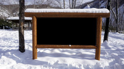 blank signage wood frame in the forest snow winter