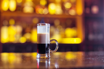 Multi-layered cocktail on bar