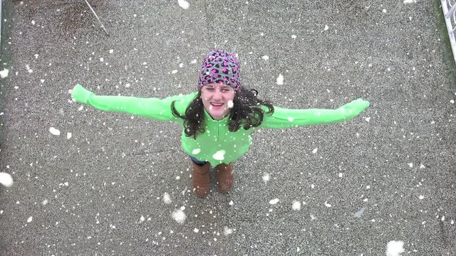 Girl turning enjoying first snow 
