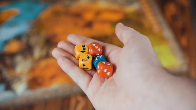 Several Colored Dices Fall On a Table With Boardgame