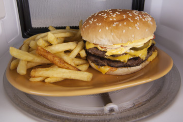 Hamburger and fries on plate isolated microwave
