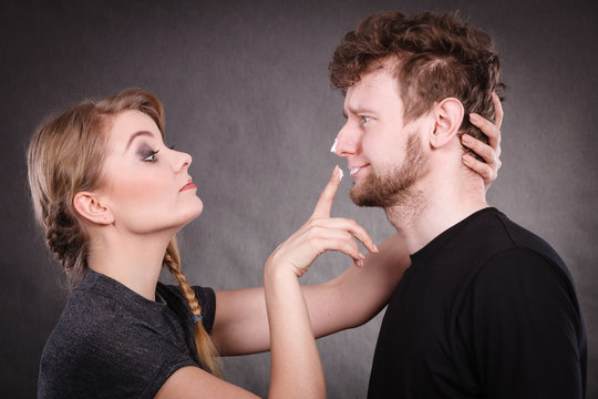Woman applying cream to her man face.