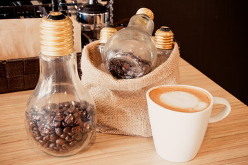 coffee cup and container of coffee beans in coffee shop vintage style