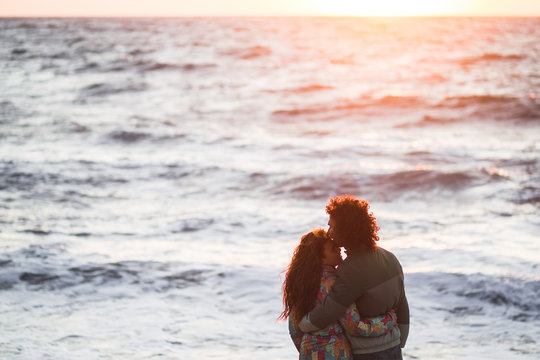 Couple in love on the beach at sunset. Romantic moments together