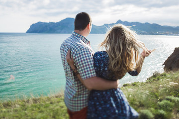 Couple walking outroors by te sea and enjoying beautiful mountain views in Crimea