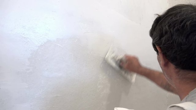 plasterer concrete worker at wall 