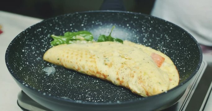 Frying healthly omelet on hot pan - UHD footage, 4K