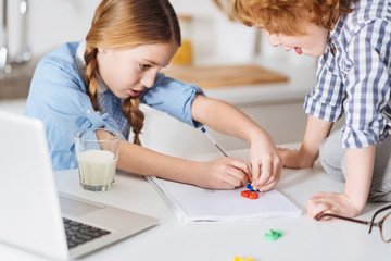 Enthusiastic clever child outlining the number with a pen