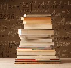 Books on vintage background with math formulas